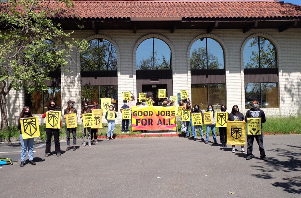 Members of Sunrise Movement Sonoma County rally in front of Rep. Mike Thompson's office in Santa Rosa, California.