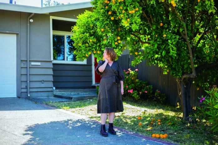 Photo by Nina Riggio for CalMatters UNINSURED Ashley Raveche stands in her front yard thinking about the future of fire for her neighborhood in Mill Valley on Friday, May 20.