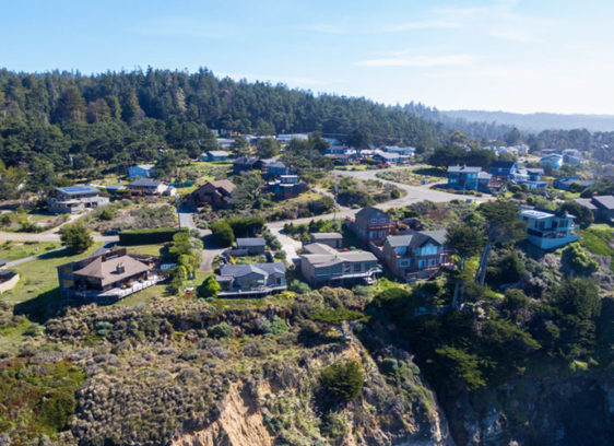 Drone aerial of California coast with houses in northern California