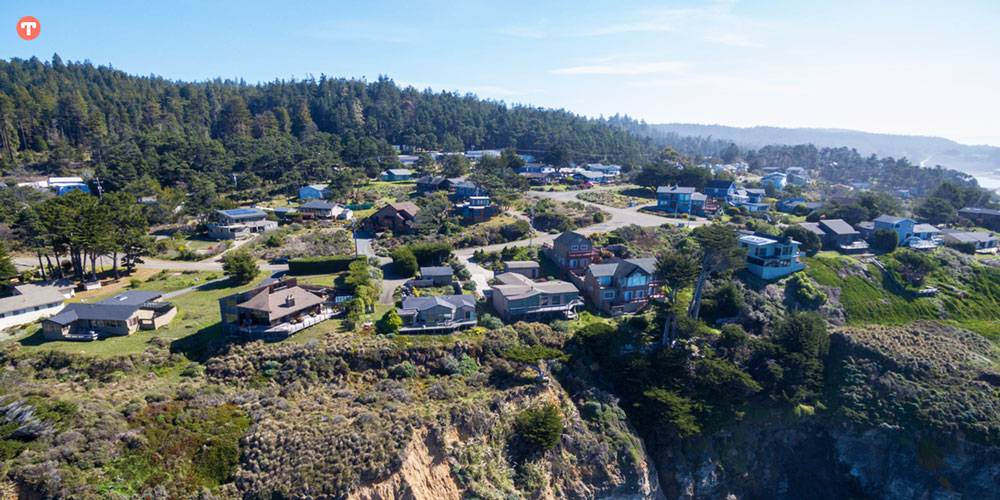 Drone aerial of California coast with houses in northern California