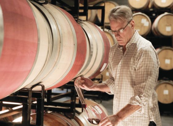 Lauded Legacy: Courtney Benham Reignites a Wine Icon Courtney Benham of CMB Family of Wines pours a glass of wine from a barrel.