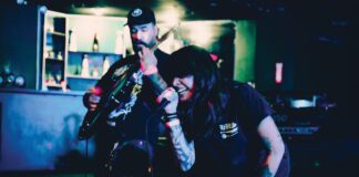 Two musicians performing on stage at a punk and metal music festival