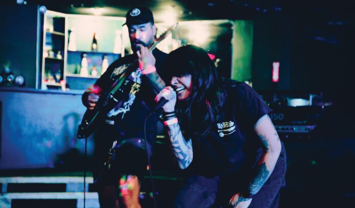Two musicians performing on stage at a punk and metal music festival