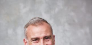 Dr. Damien Wilson wearing a dark sportscoat and blue shirt