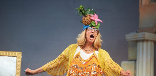 Lori Haley Fox onstage in costume during a performance of 'Mamma Mia1'