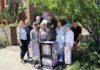 Micah’s Hugs volunteers and local officials standng beside a free Narcan box.