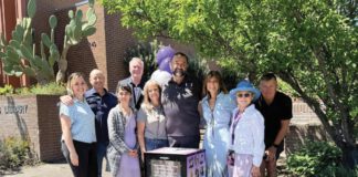 Micah’s Hugs volunteers and local officials standng beside a free Narcan box.