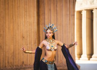 The Cosbunny, Award-Winning Cosplay Artist to Judge at SonomaCon A cosplayer in an ornate gold headdress and jeweled costume poses dramatically in front of stone columns.