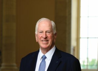 Rep. Mike Thompson Fights Fire With Fire, Defends Prop. 50 Rep. Mike Thompson stands smiling in a dark suit, white shirt and blue tie inside a government building.